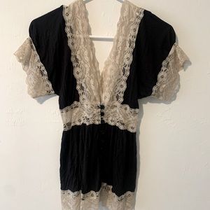 Deep v neck black shirt with beige lace trimming